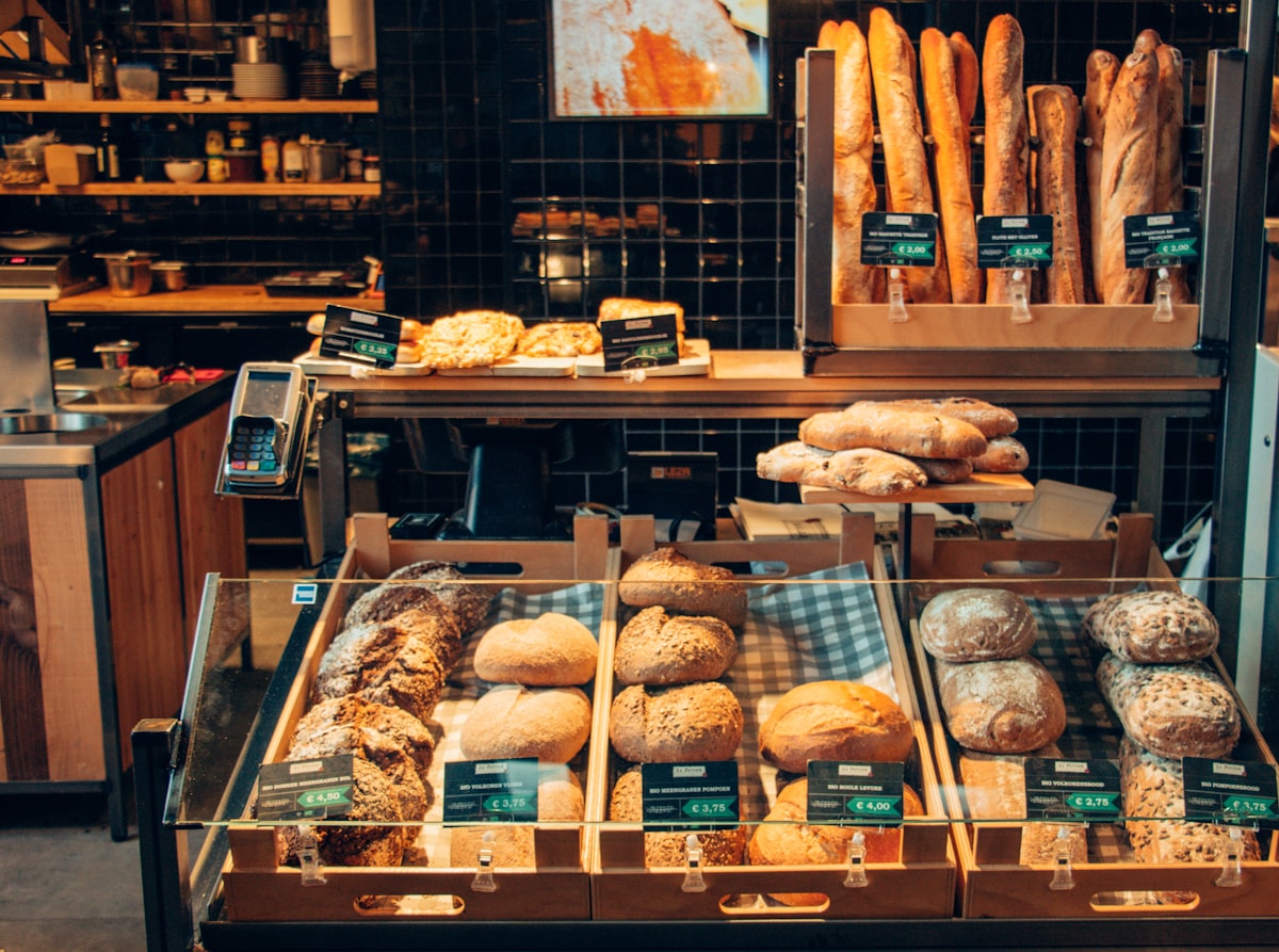 Counter lined with trays of fresh bakery goods